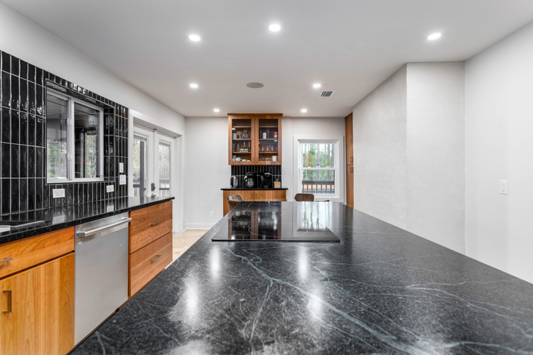 Kitchen with waterfall counter at Group Retreat in Fairhope, Alabama
